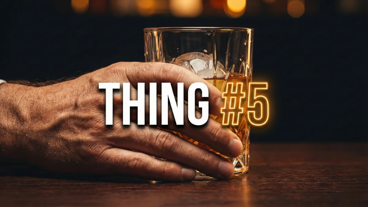 Close up of man's hand holding whiskey glass on a date